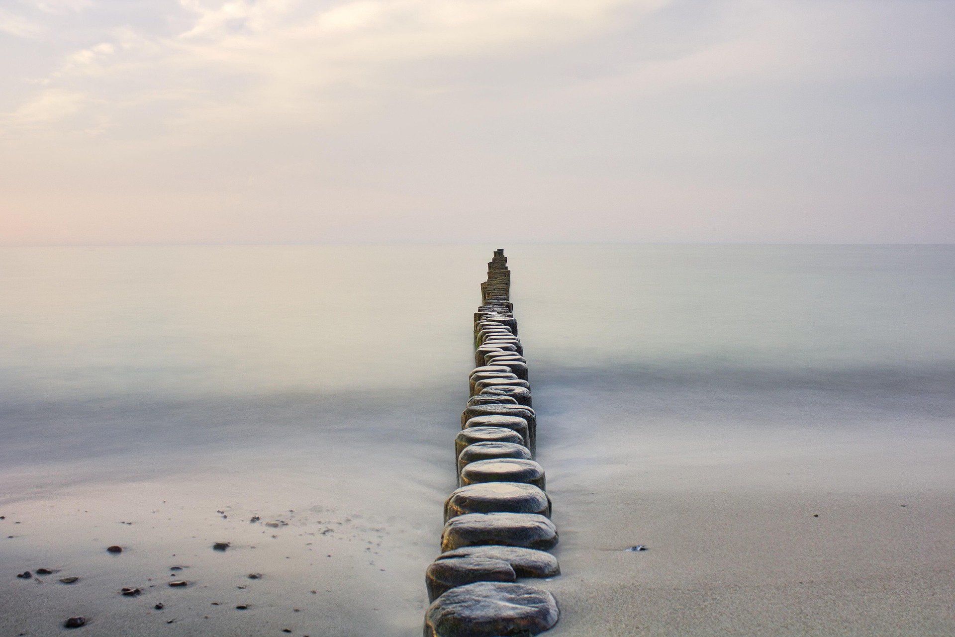 Stepping stones across calm water.